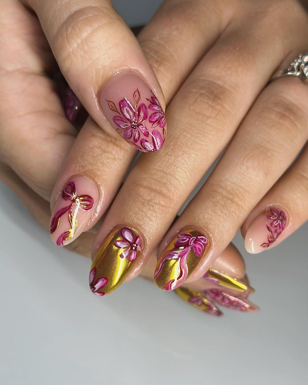 Pink and Gold Almond Nails with Floral Patterns