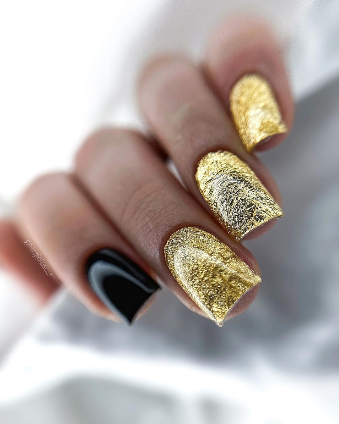 Golden Textured Metallic Nails with One Black Accent Nail