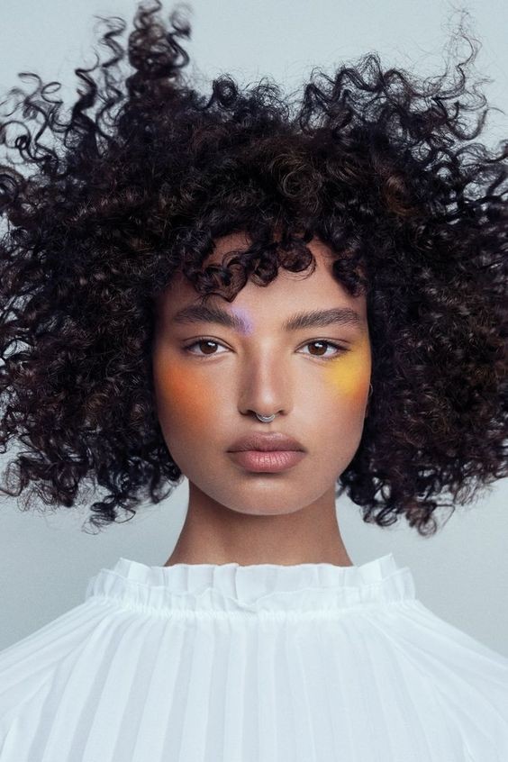 The Bold and Bright Artistic Makeup with Curly Mane