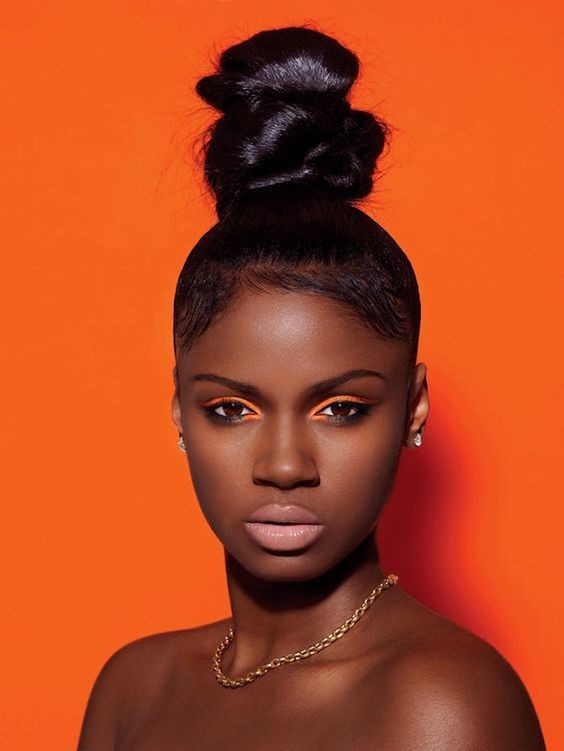 Sleek Bun with a Bold Backdrop