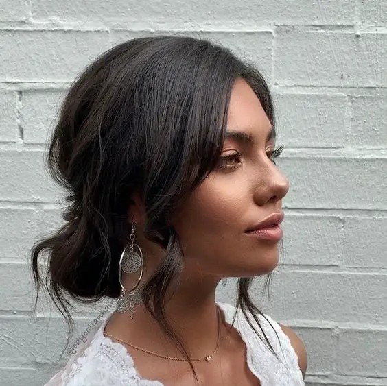 Low Messy Bun with Face-Framing Layers