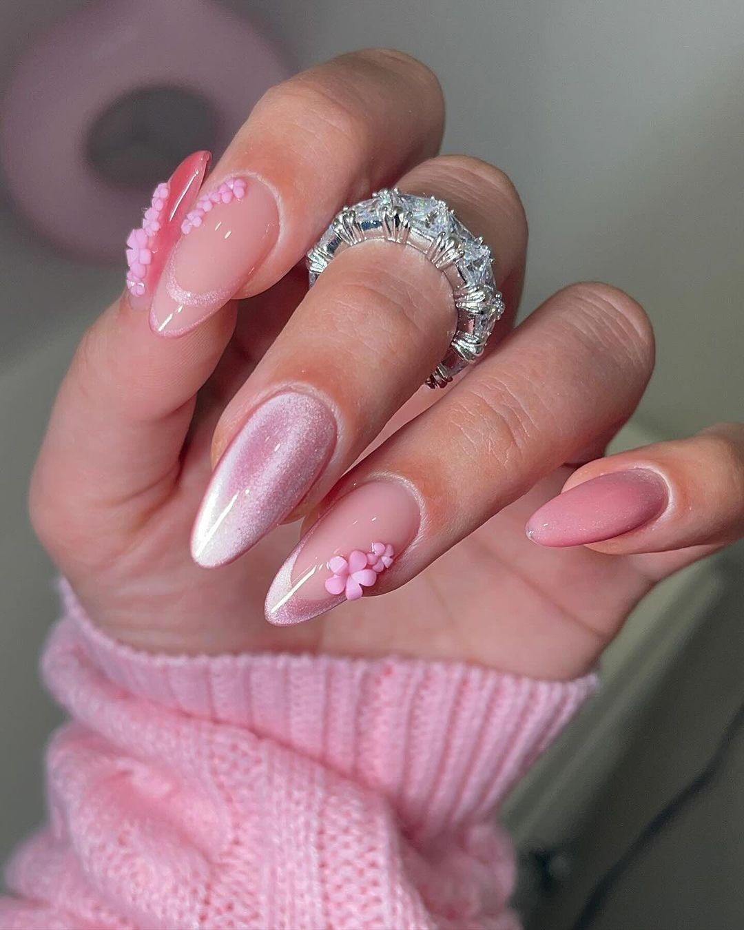 Pink Almond-Shaped Nails with Glitter, Lace Details, and Petal Appliqués