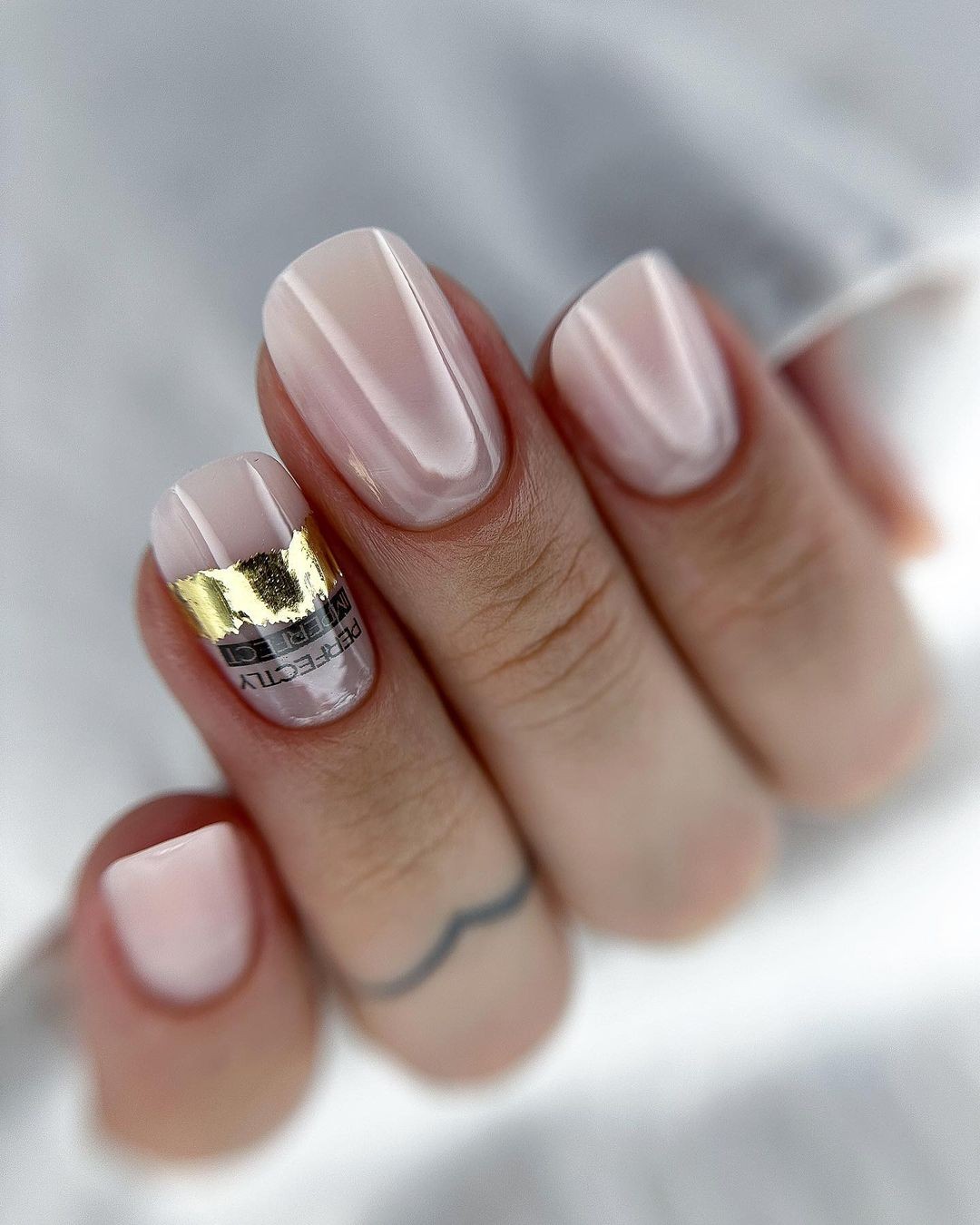 Manicure with a Golden Foil Accent on the Ring Finger