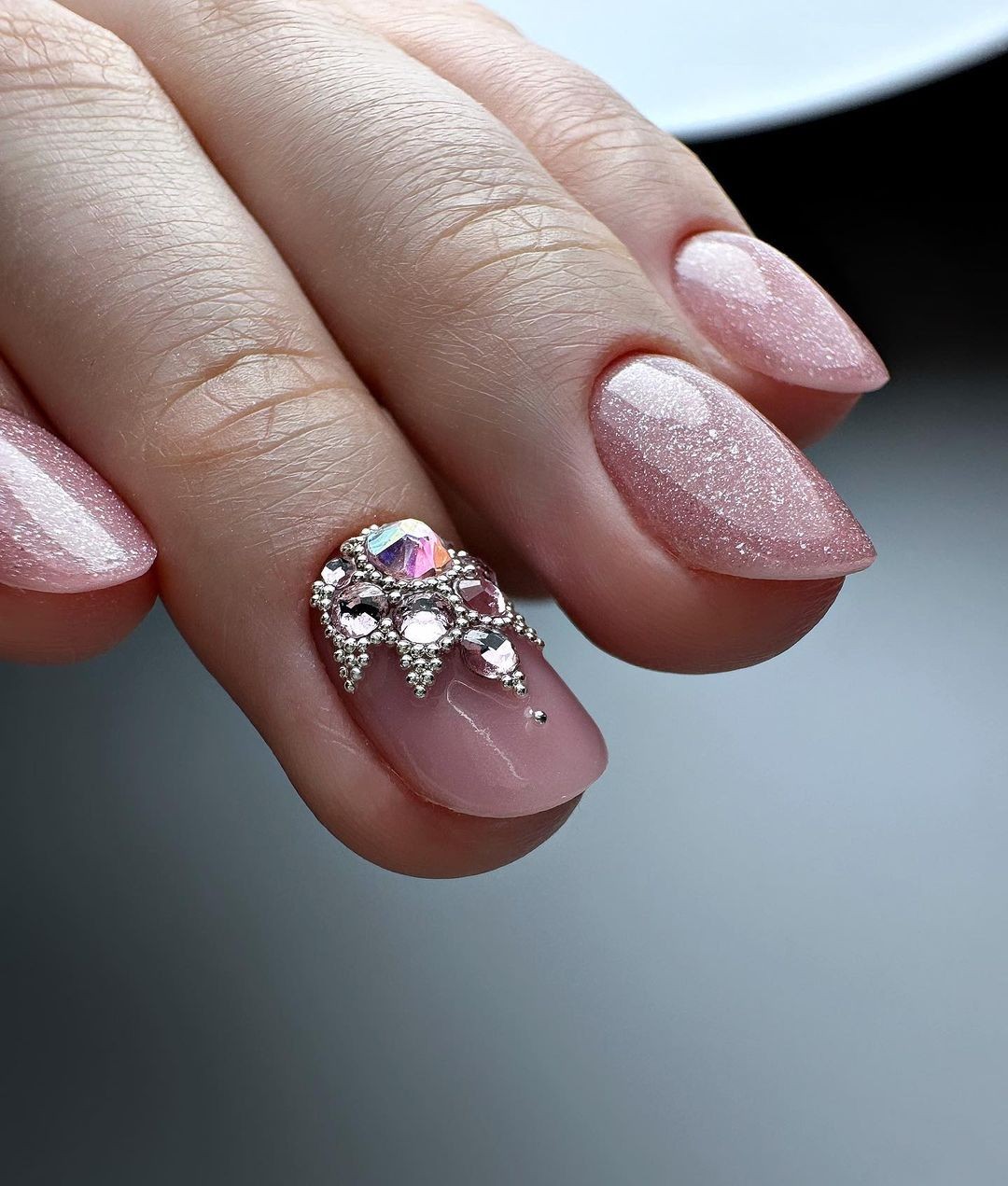 Sparkly Pink Almond-Shaped Nails with a Jeweled Accent Nail