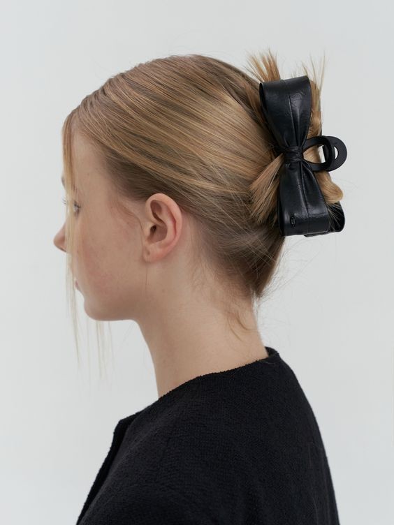 Chic Leather Bow on a Classic Bun