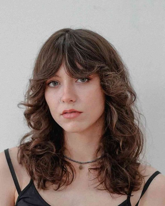 Wavy Hair with Boho Bangs: Playful Elegance