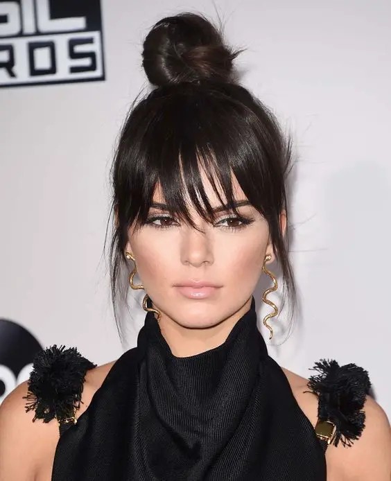 Messy Top Knot with Wispy Bangs