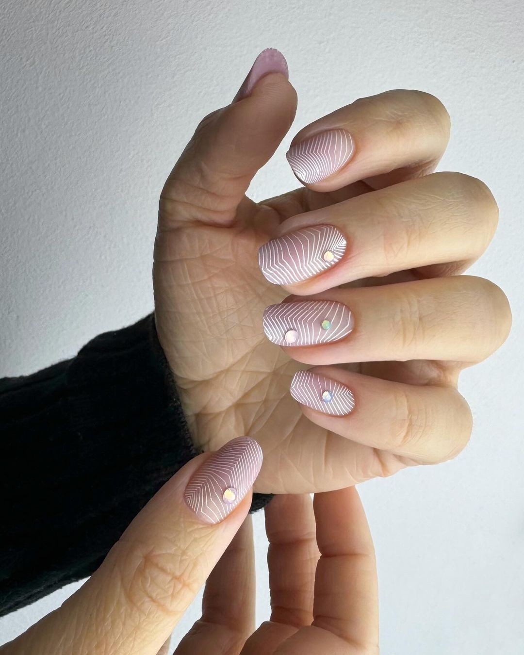 Pink Nails with White Geometric Lines and Rhinestone Accents