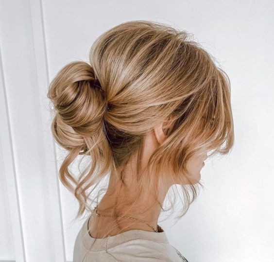 Messy Bun with Face-Framing Pieces: