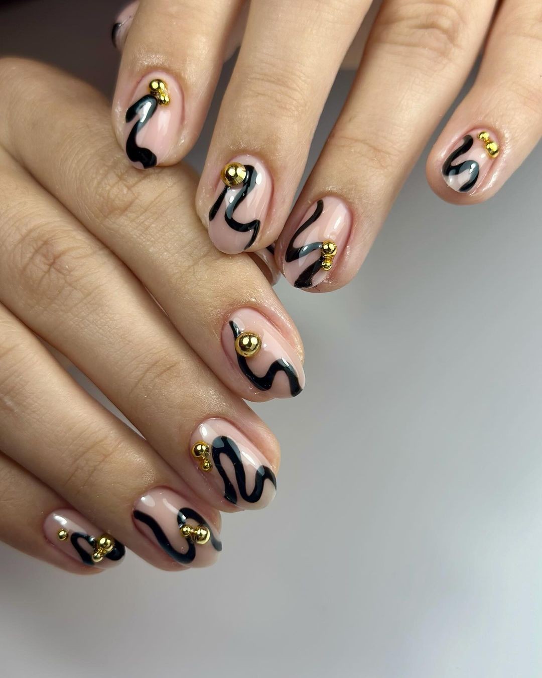 Sheer Nails with Abstract Black Swirls and Gold Embellishments