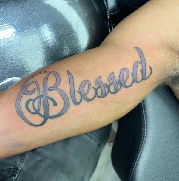 Blessed tattoo on bicep