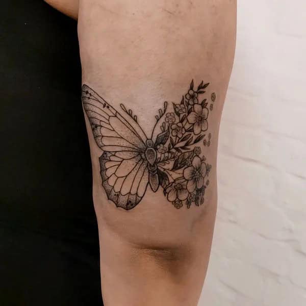 Half butterfly half flower forearm tattoo