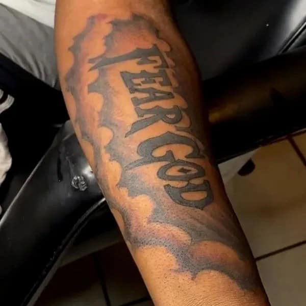 Fear God Tattoo on Forearm