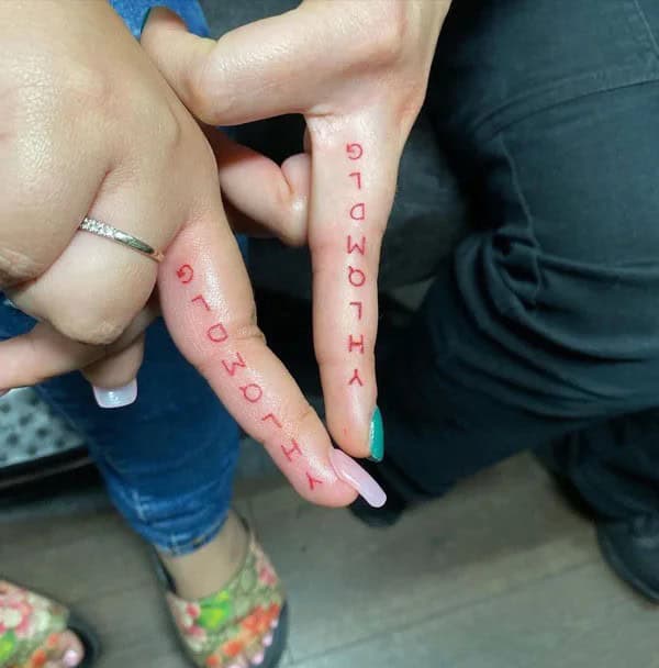 “YHLQMDLG” Finger Tattoo