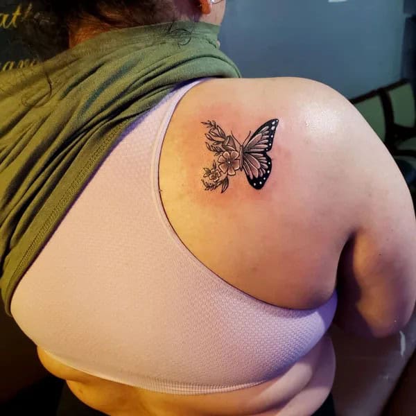 Half butterfly half flower forearm tattoo