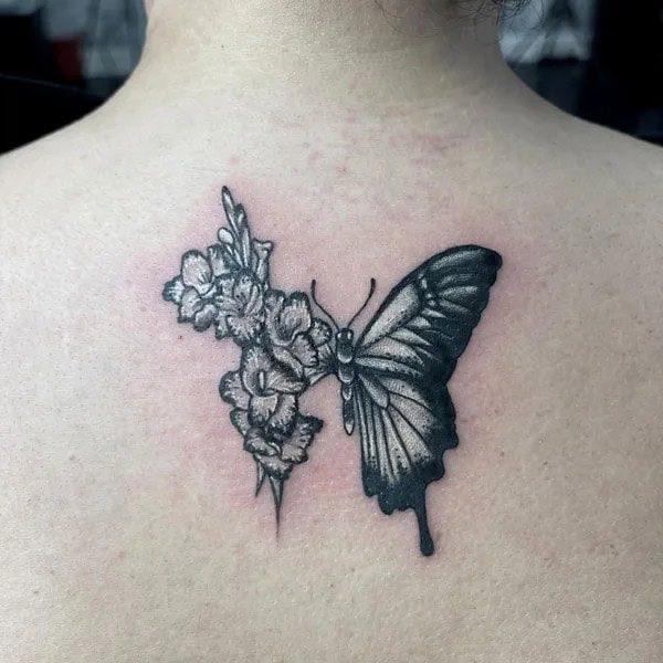 Half butterfly half flower forearm tattoo