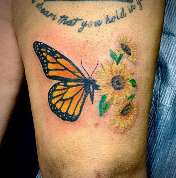 Half butterfly half flower forearm tattoo