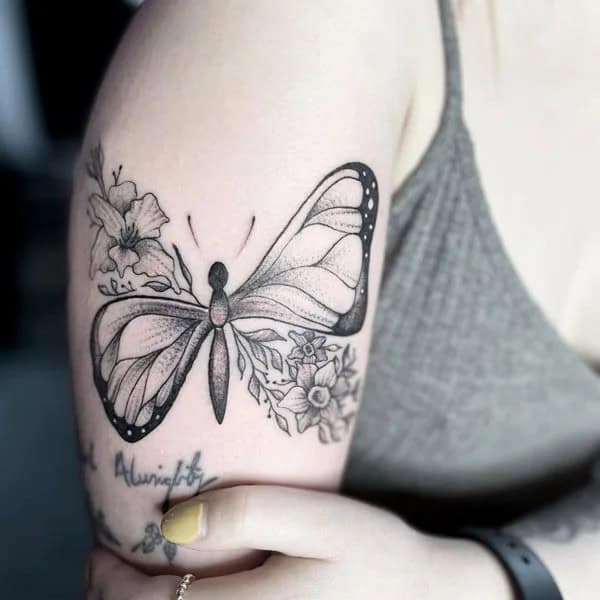 Half butterfly half flower forearm tattoo