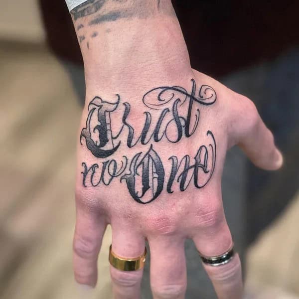 “Trust No One” Hand Tattoo