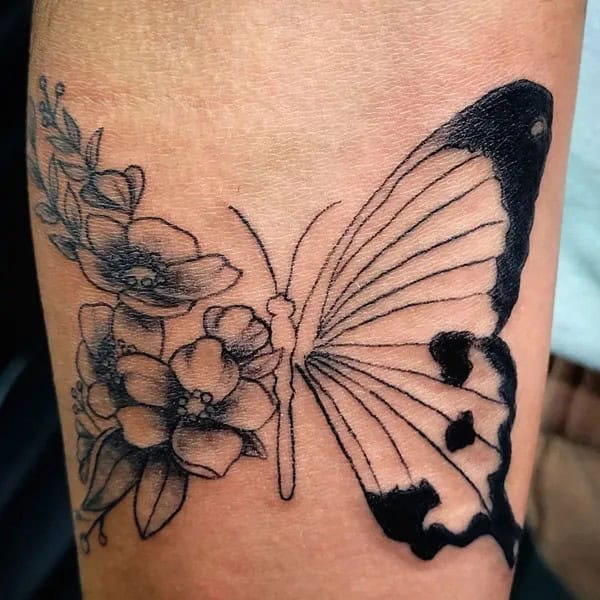 Half butterfly half flower forearm tattoo