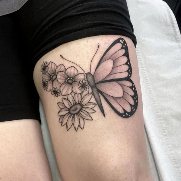 Half flower half butterfly thigh tattoo