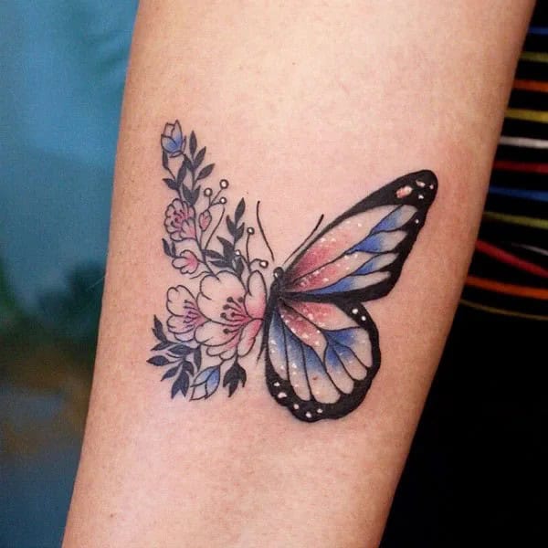 Half butterfly half flower forearm tattoo