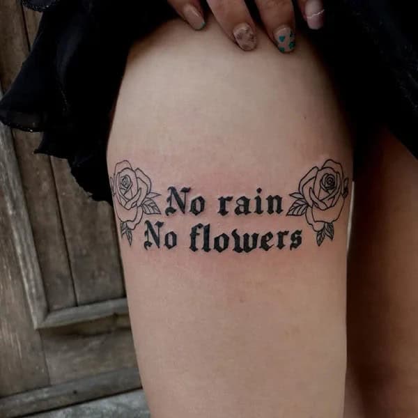 “No Rain No Flowers” Tattoo on Thigh