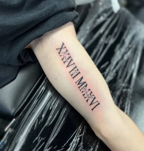 Roman Numeral Bicep Tattoo