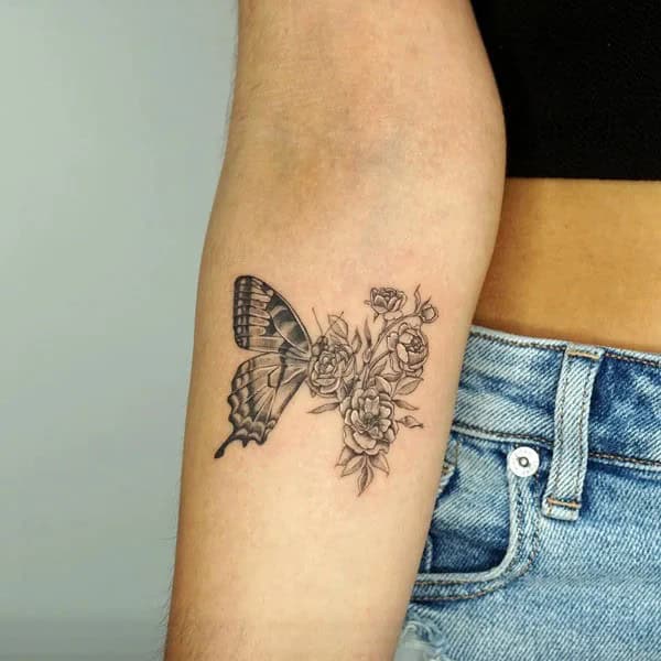 Half butterfly half flower forearm tattoo