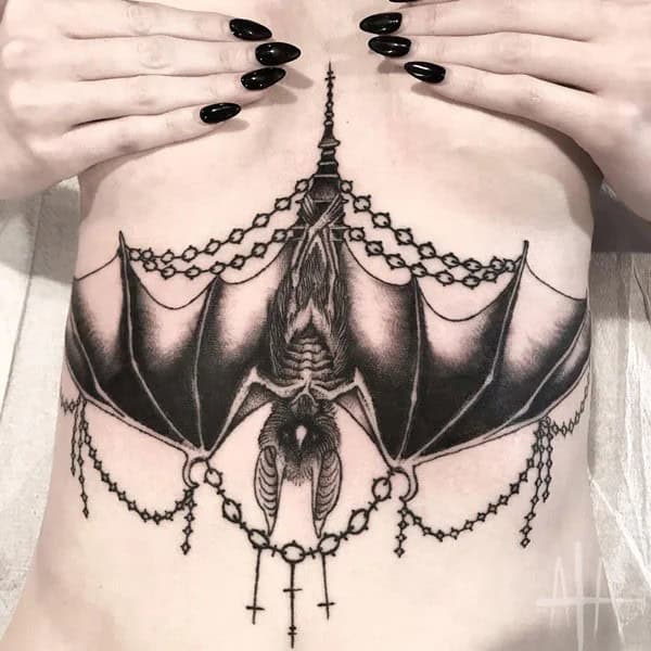 Bat Under Breast Tattoo