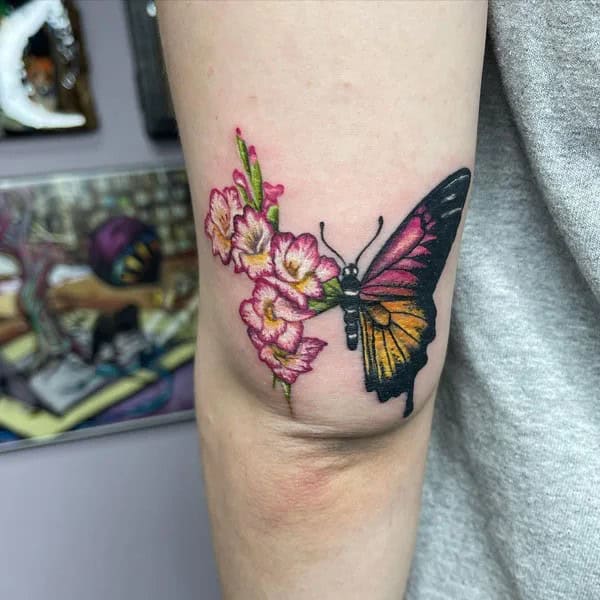 Half butterfly half flower forearm tattoo