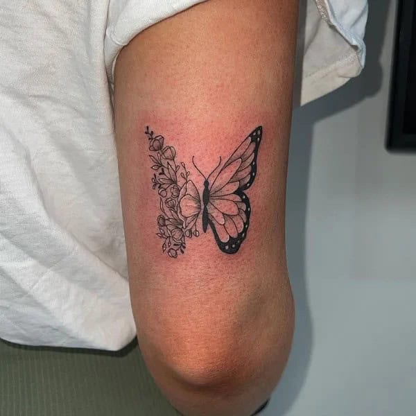 Half butterfly half flower forearm tattoo