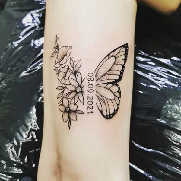 Half butterfly half flower forearm tattoo