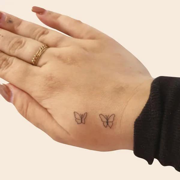 Butterfly Outline Hand Tattoo