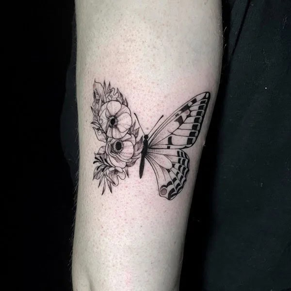 Half butterfly half flower forearm tattoo