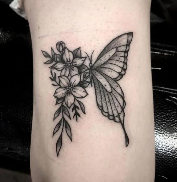 Half butterfly half flower forearm tattoo