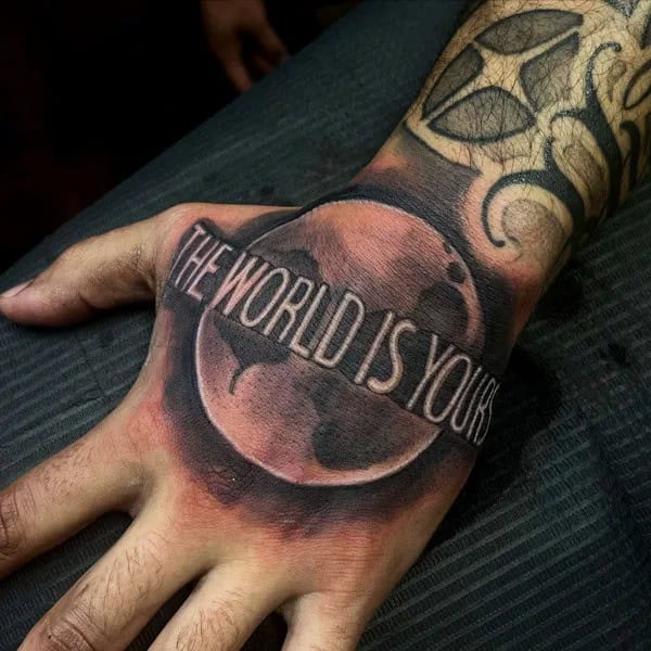 “The World Is Yours” Hand Tattoo