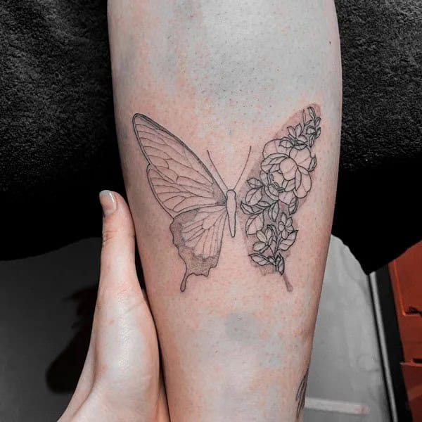 Half butterfly half flower forearm tattoo