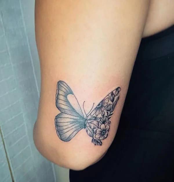 Half butterfly half flower forearm tattoo