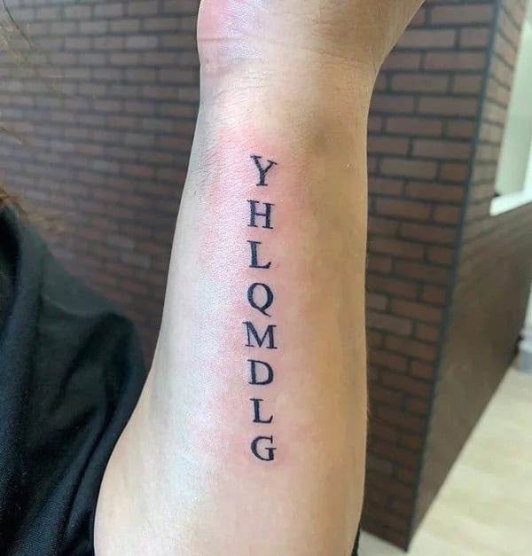 “YHLQMDLG”  Forearm Tattoo