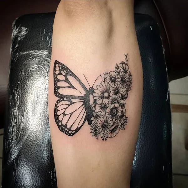 Half butterfly half flower forearm tattoo