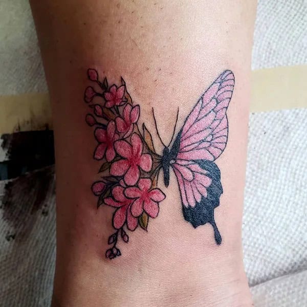 Half butterfly half flower forearm tattoo