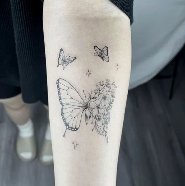 Half butterfly half flower forearm tattoo