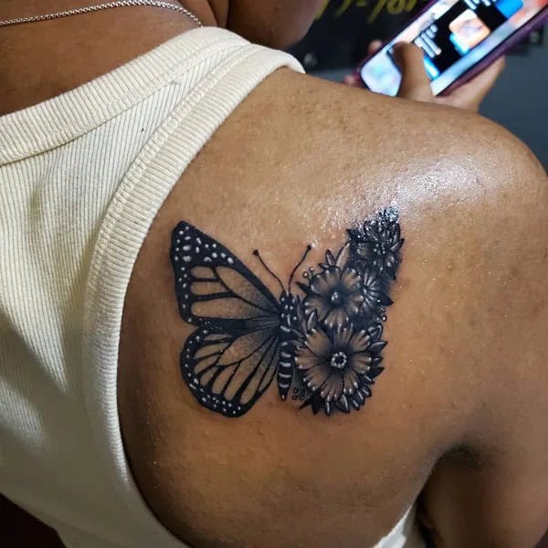 Half butterfly half flower forearm tattoo