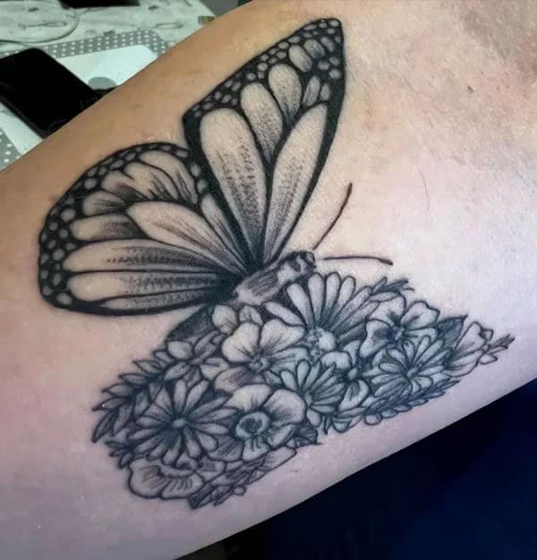 Half butterfly half flower forearm tattoo