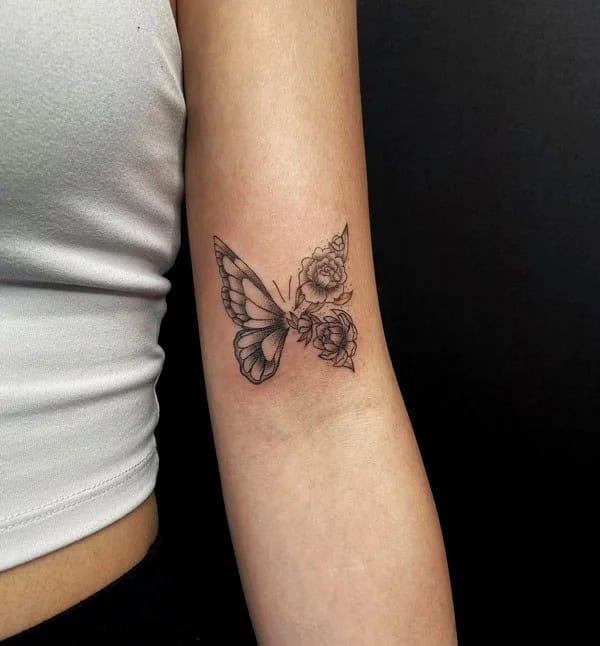 Half butterfly half flower forearm tattoo