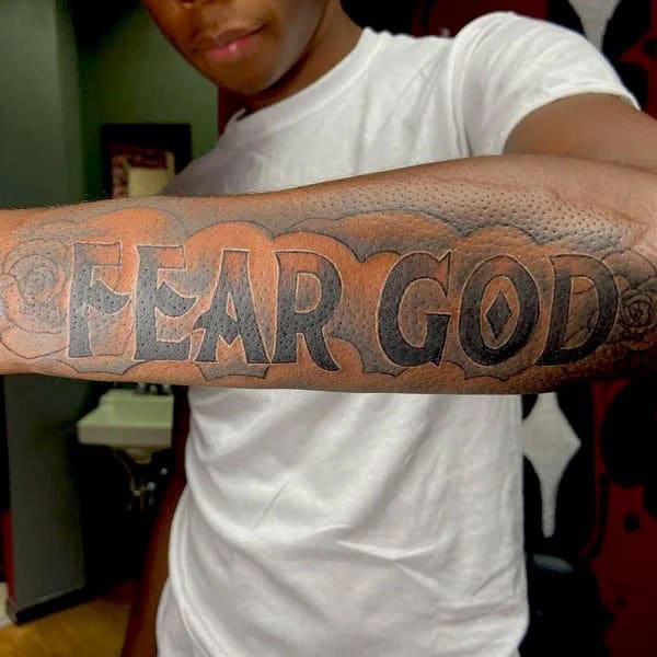 Fear God Tattoo on Forearm