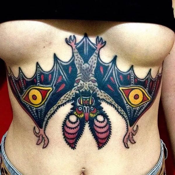 Bat Under Breast Tattoo