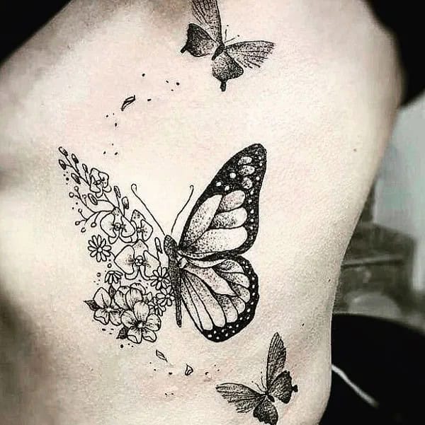 Half butterfly half flower forearm tattoo