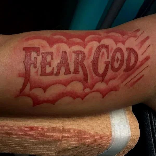 Fear God Tattoo on Bicep